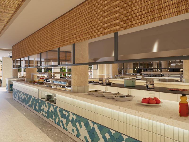 Spacious buffet area with tiled counters, food trays, and hanging sneeze guards in a hotel dining space.