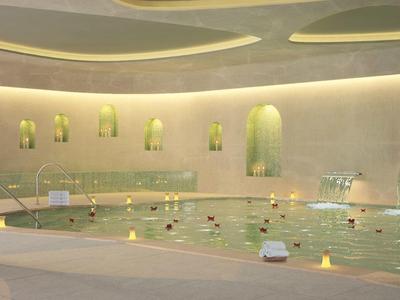 Moderner Spa mit großem Innenpool, sanfter Beleuchtung und entspannenden Dekoakzenten in warmen Farben.