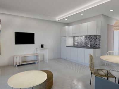 Salon lumineux moderne avec kitchenette, table à manger et design minimaliste.