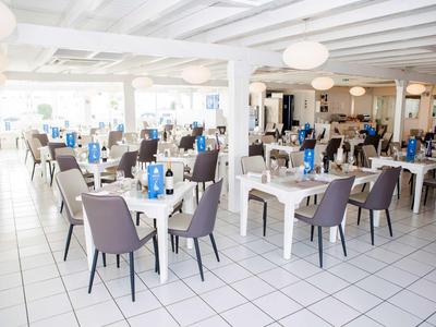 Brightly lit dining room with modern tables and chairs.