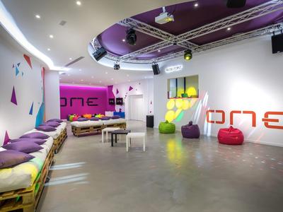 Modern lounge area with colorful seating and vibrant wall decorations.