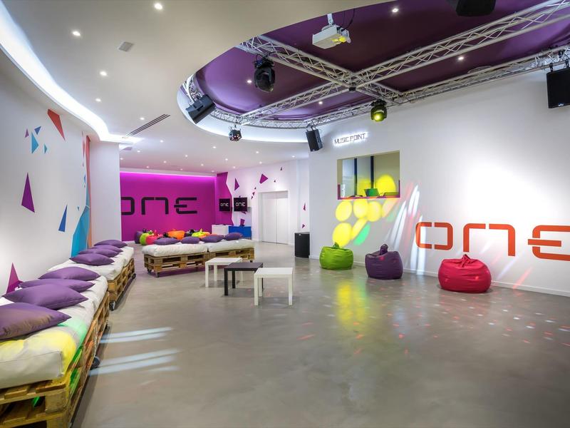 Modern lounge area with colorful seating and vibrant wall decorations.