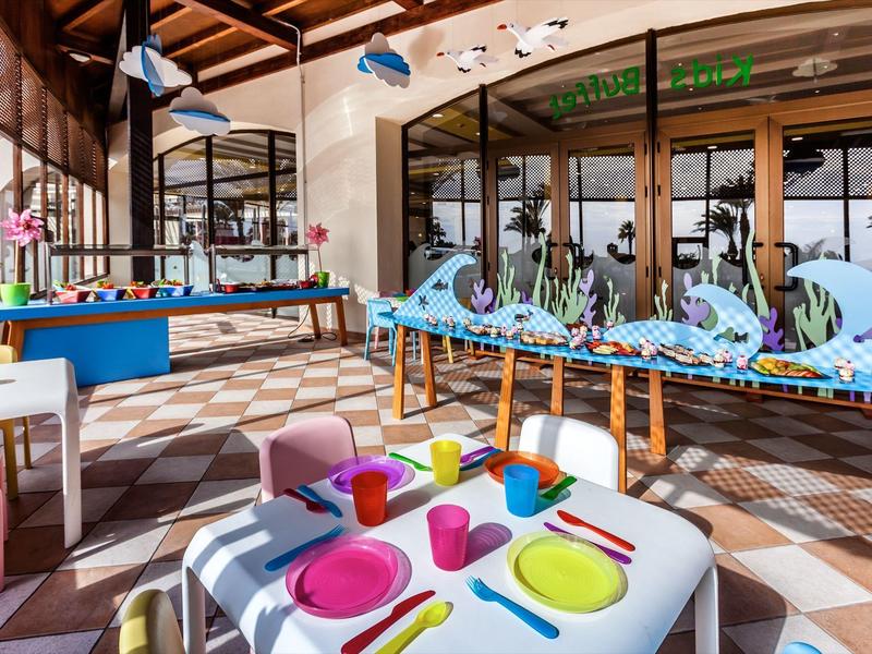 Indoor family-friendly activity area with table games and colorful kid-sized seating.