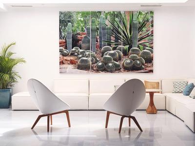Modern living room with white furniture and plants, large wall art displayed.
