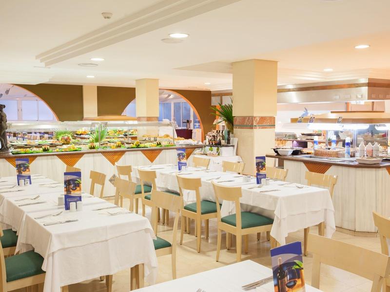 Bright buffet restaurant with set tables and chairs, modern interior design.