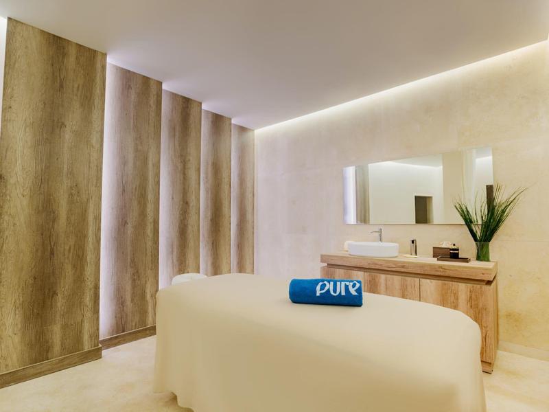 Bright, modern massage room with relaxing ambiance and neat décor.