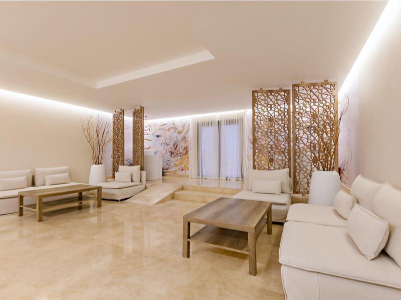 Bright modern lounge area with sofas, tables, and decorative partitions