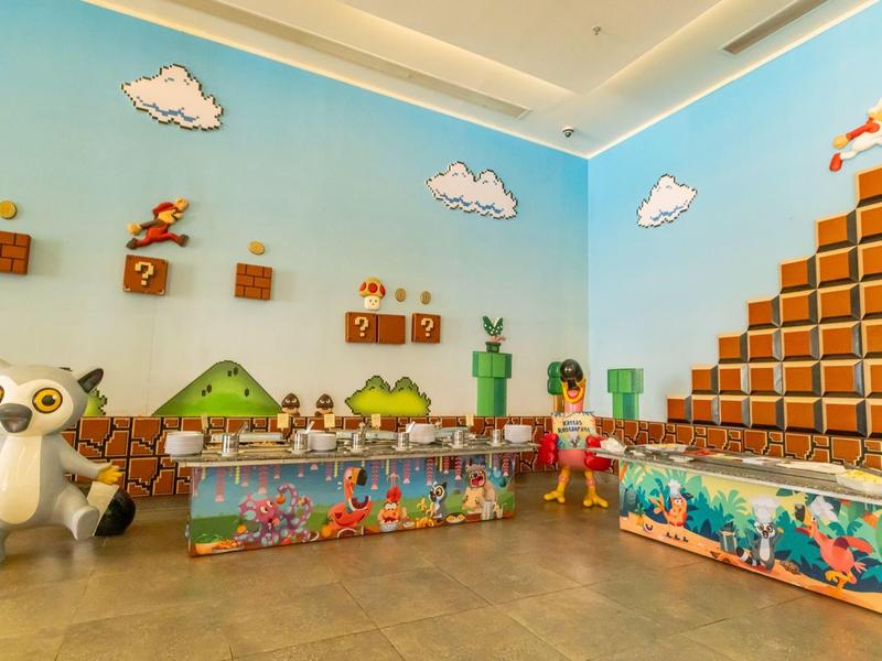 Una stanza colorata con decorazioni murali e figure a tema Super Mario.