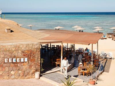 Restaurant de plage avec auvent face à la mer et plage de sable