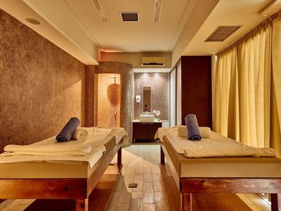 Relaxation room with two massage tables and soft lighting