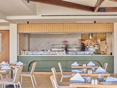 Modern restaurant with set tables and buffet area with buffet lighting