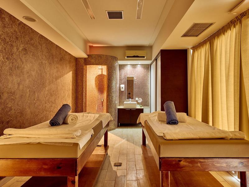 Relaxation room with two massage tables and soft lighting