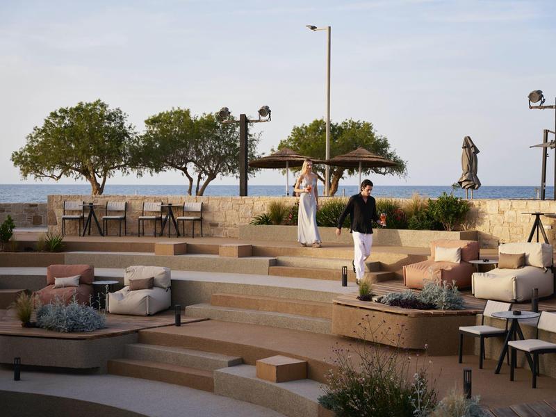 Modern terraced outdoor area with seating and sea view.