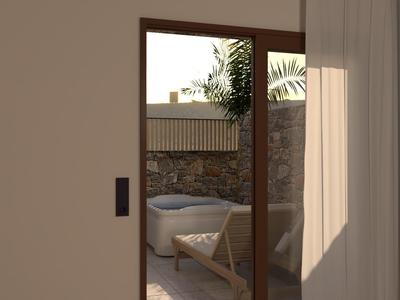 Porte ouverte vers un balcon avec jacuzzi et coin salon, à l'ombre et au soleil.