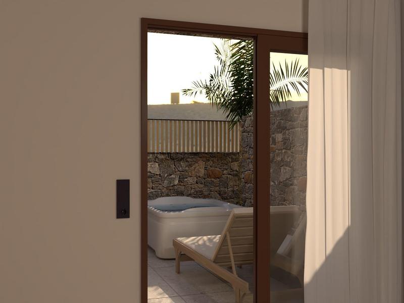 Porte ouverte vers un balcon avec jacuzzi et coin salon, à l'ombre et au soleil.