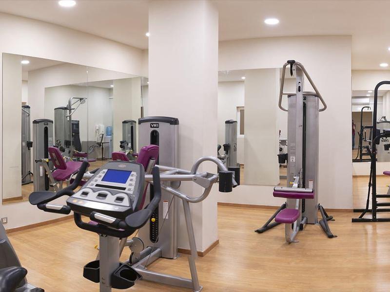 Nowoczesna siłownia z różnymi urządzeniami do ćwiczeń i jasnym oświetleniem