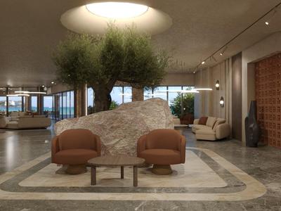 Moderne hotel lobby met grote stenen, planten en comfortabele stoelen.