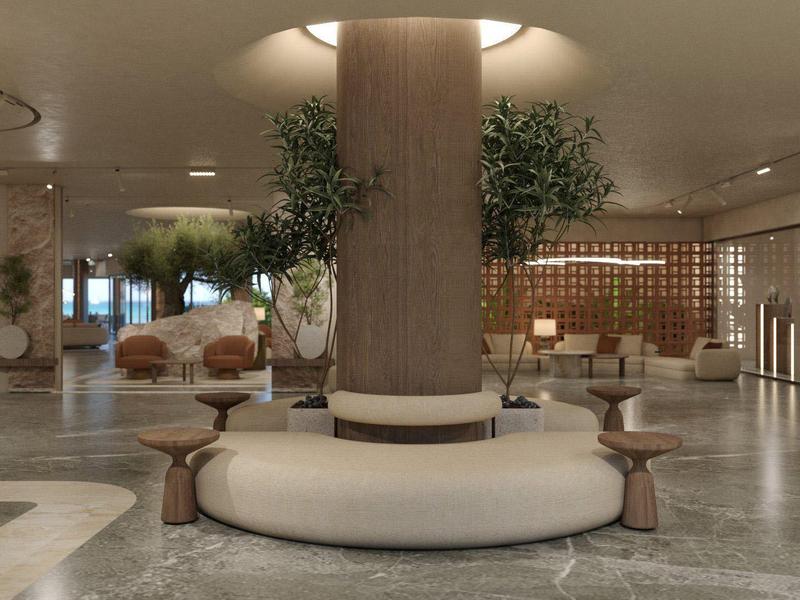 Un vestíbulo de hotel moderno con banco circular alrededor de una columna y iluminación elegante.