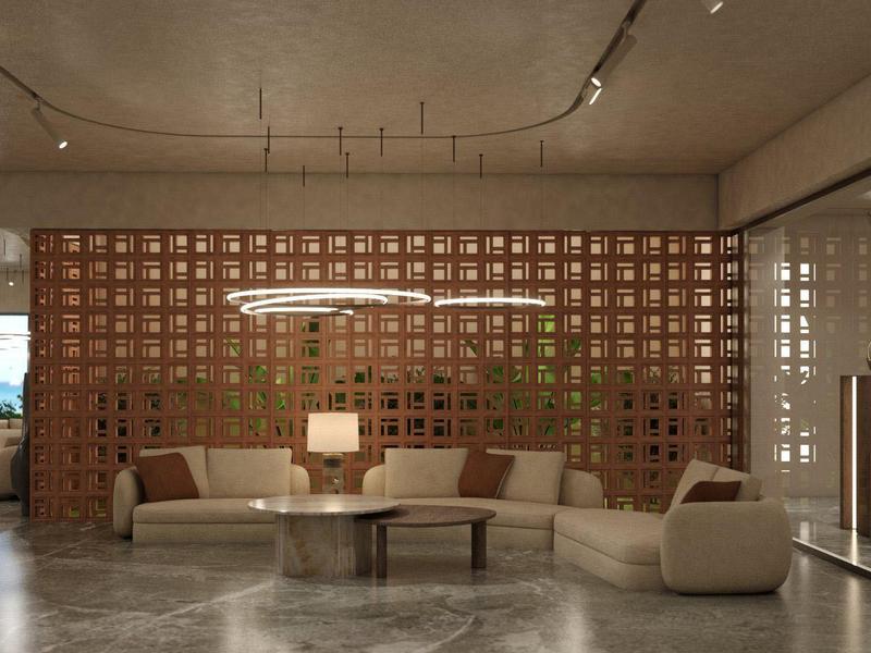Moderna recepción de hotel con zona de estar acogedora, mesa redonda y estructura de pared de madera iluminada.