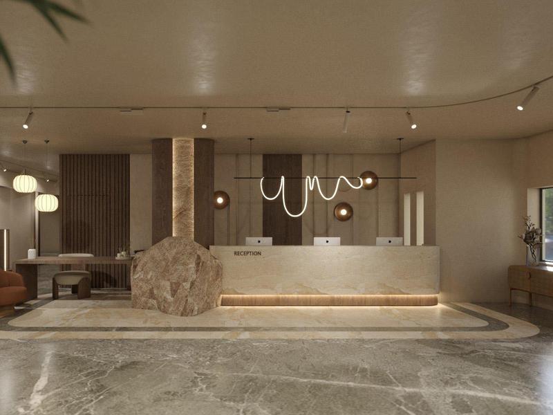 Área moderna de vestíbulo de hotel con recepción, asientos y luz natural.