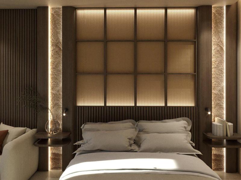 Dormitorio moderno con cama grande, almohadas suaves y luz indirecta en la pared.