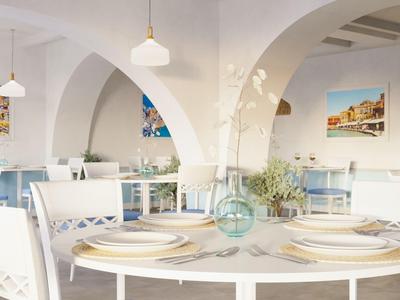 Jasna restauracja z białymi meblami i dekoracyjnymi obrazami na ścianach.