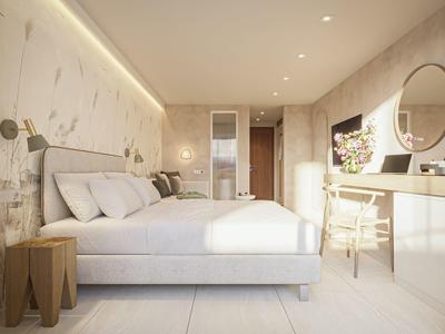 Chambre d'hôtel moderne avec grand lit, tables de chevet, coiffeuse et miroir rond.