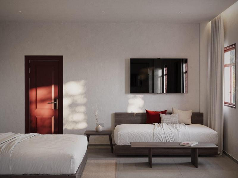 Modernes Hotelzimmer mit zwei Betten, großem Spiegel und hellem Tageslicht.