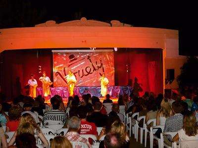 Nächtliche Bühnenshow mit Tänzern und vielen Zuschauern im Freilufttheater eines Hotels.