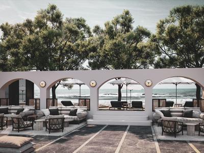 Moderner Außenbereich mit weißen Rundbögen, Lounge-Möbeln und Blick auf Meer und Bäume.