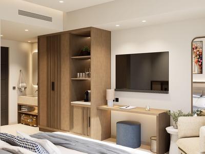 Habitación de hotel moderna con TV, armario, zona de estar y esquema de colores neutros.