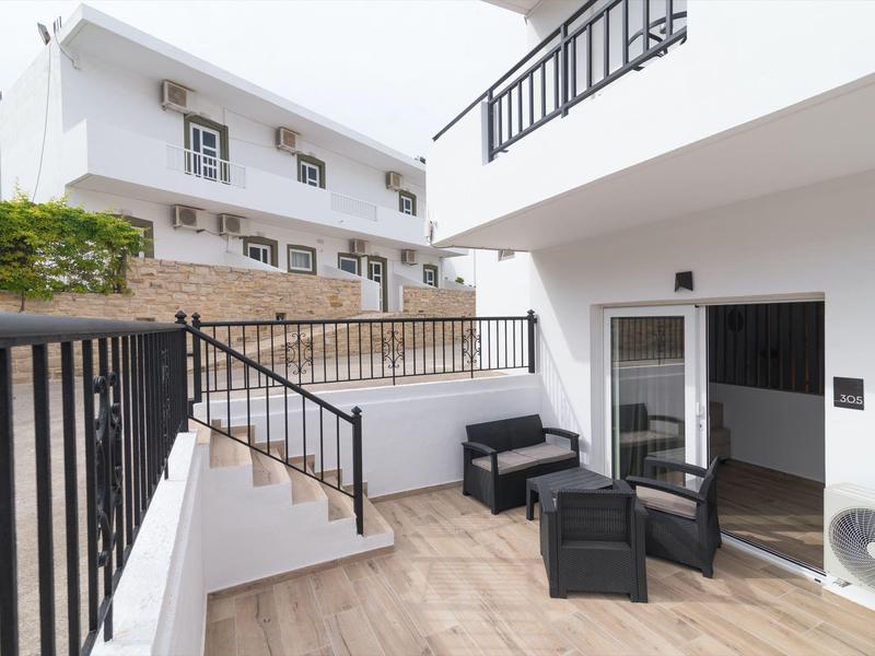 Moderne buitenruimte met zitplaatsen, trap en witte gevels