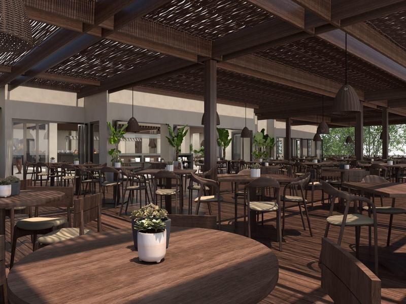 Large covered outdoor dining area with many wooden tables and plants.