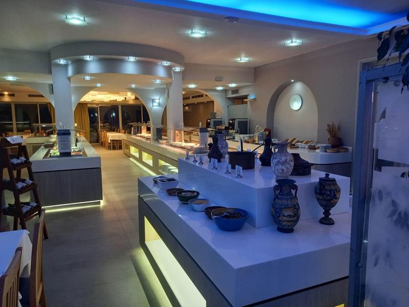 Nowoczesna przestrzeń restauracyjna z podświetlanymi ladami i dekoracyjnymi wazonami.