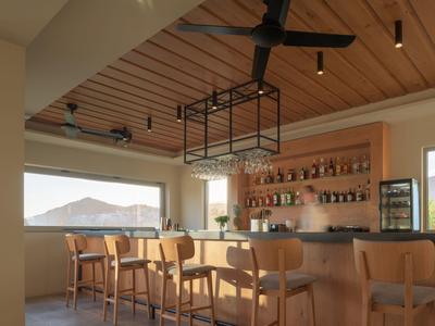 Bar moderno con sgabelli in legno, grande finestra e soffitto in legno con ventilatore.
