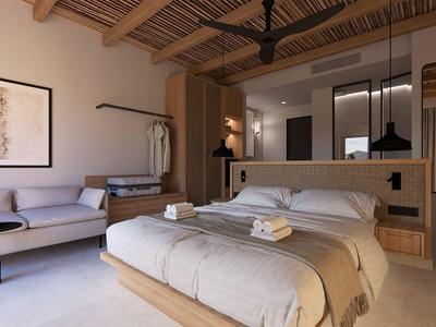 Camera d'hotel moderna con letto matrimoniale, divano e soffitto in legno a vista.