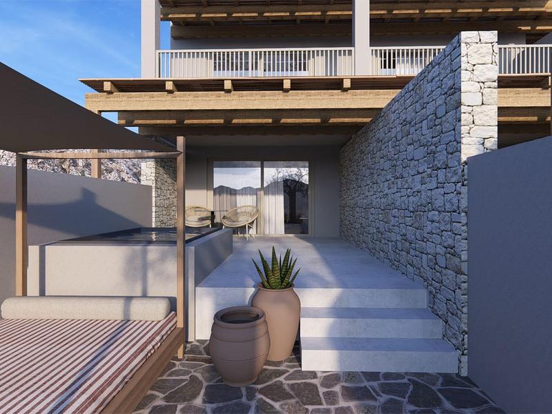 Ingresso moderno con pareti di pietra e vasi di piante, atmosfera tranquilla e soleggiata.