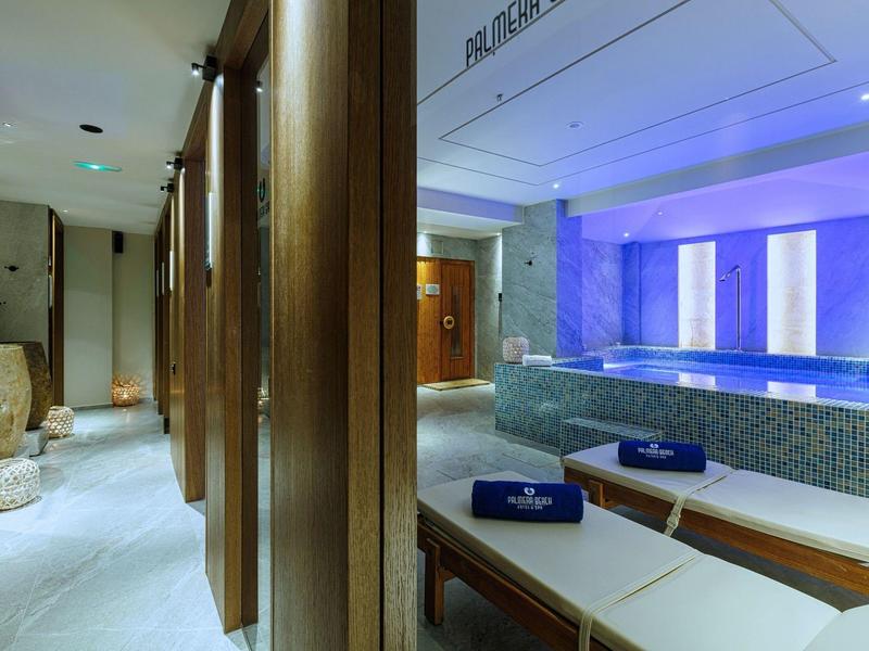 Elegant spa area with heated pool, loungers, and soft lighting.