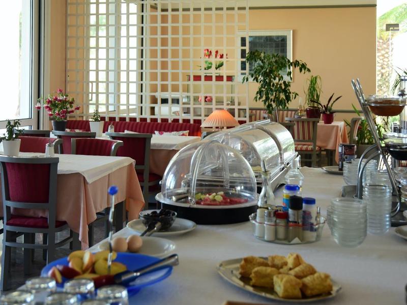 Stůl připravený na snídani s jídlem před posezením v světlé kavárně.