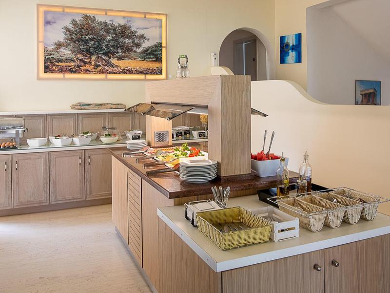 Buffet area with drinks, cereal, and toast in a hotel breakfast room.