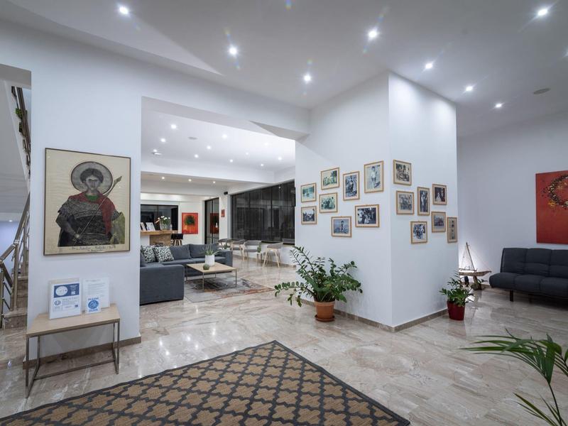 Sala de estar moderna con sofás, obras de arte y plantas en el vestíbulo de un hotel.