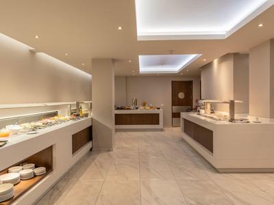 Modern breakfast room with buffet and minimalist design in neutral tones.