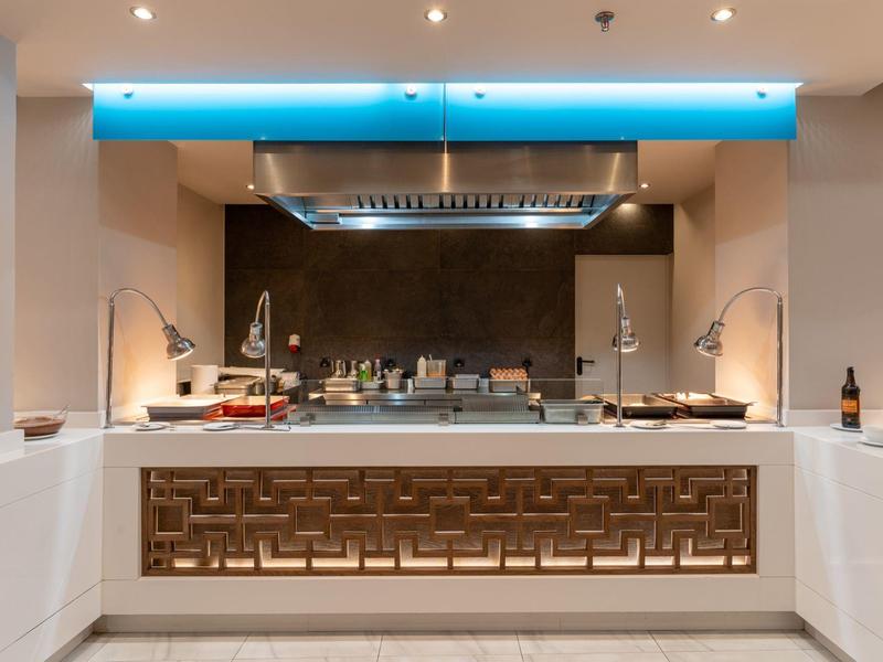 Modern hotel kitchen with bright colors and blue lighting