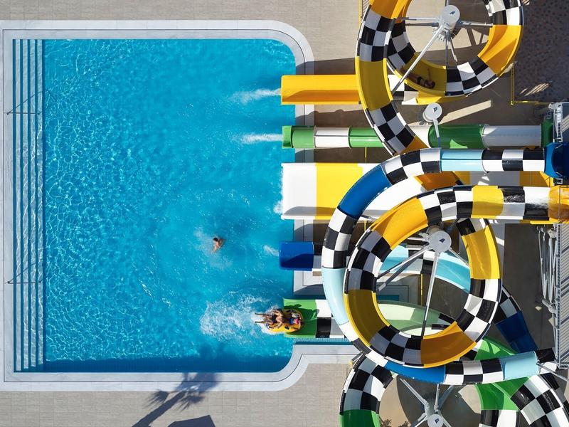 Toboggan aquatique se terminant dans la piscine avec deux personnes.