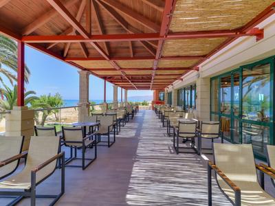 Terrazza coperta con area salotto e vista sul mare in un hotel