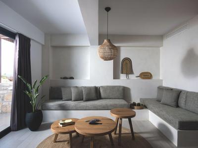 Modernes Wohnzimmer mit grauer Eckcouch, Holztischen und Dekoration neben Balkon.