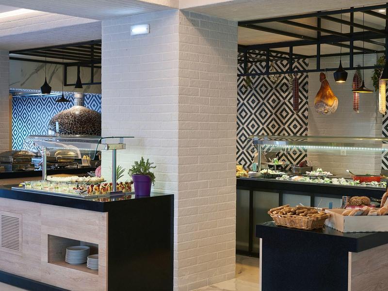 Modern buffet with pastries and decorative elements in a bright hotel restaurant.