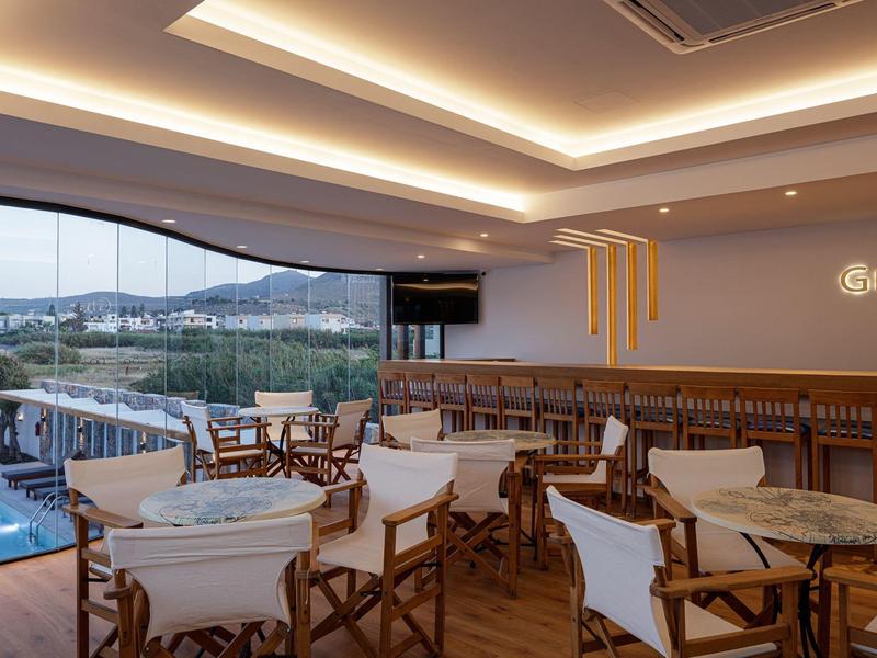 Modern restaurant with wooden chairs and panoramic view through large windows.