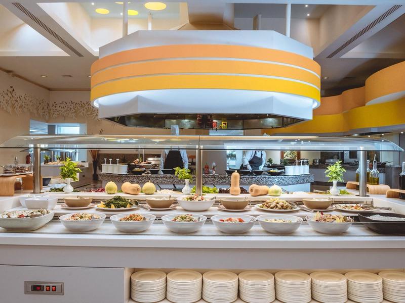 Buffet with various dishes and bowls in a modern restaurant.