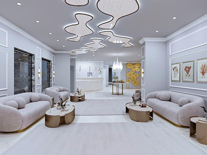 Moderner, heller Lounge-Bereich mit geschwungenem Deckendesign, grauen Sofas und runden Tischen.